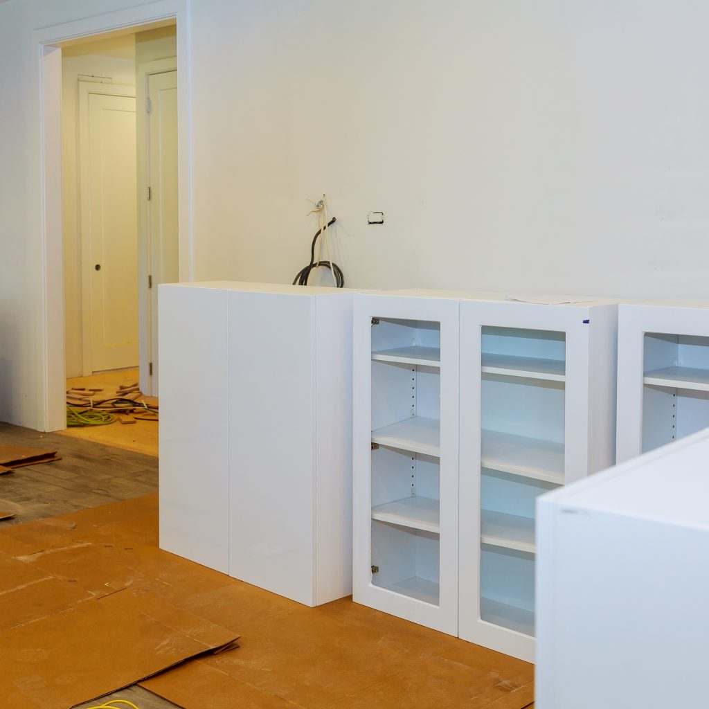 Modern domestic kitchen cabinets with new appliances and sink in kitchen